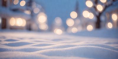 The primary subject of the image is a snowy landscape with a focus on the snow-covered ground. The setting is a winter scene with a backdrop of trees, creating a serene and peaceful atmosphere. The visual style is a photo, capturing the beauty of the snowy environment. The colors and mood are predominantly white, with the snow creating a sense of tranquility and calmness.